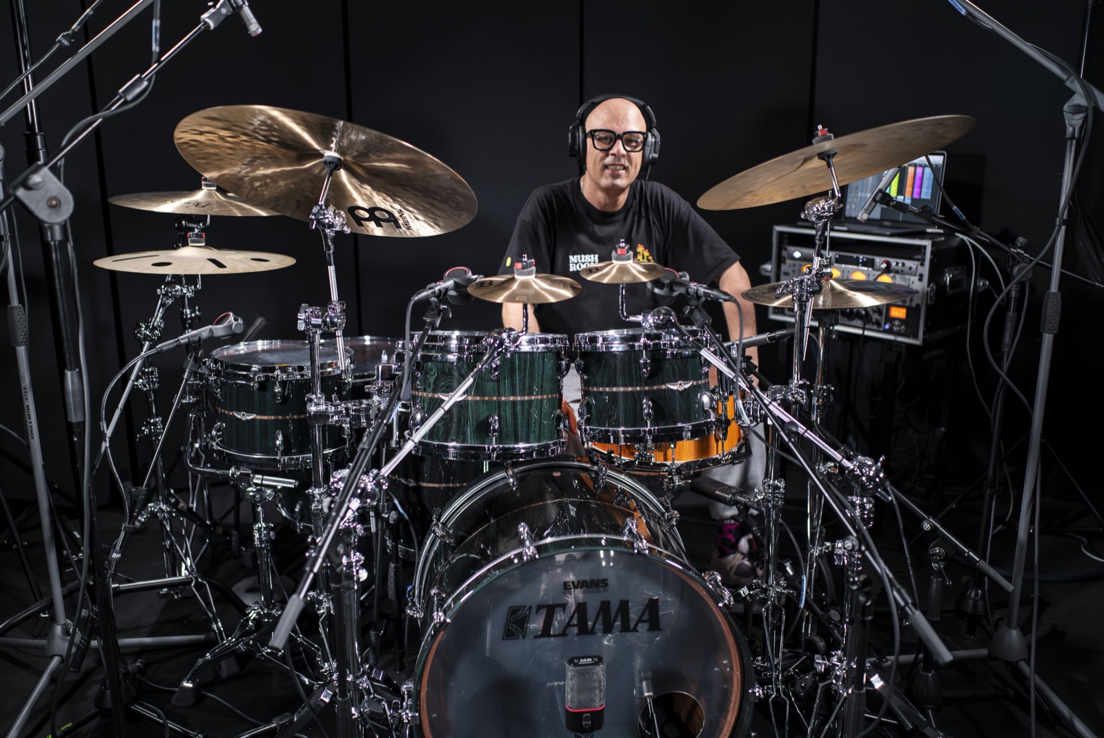 Daniele playing the full drum kit wearing headphones